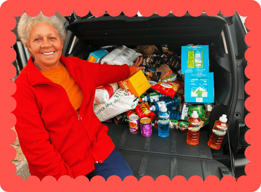 Janet with food and grocery supplies prepared for community support