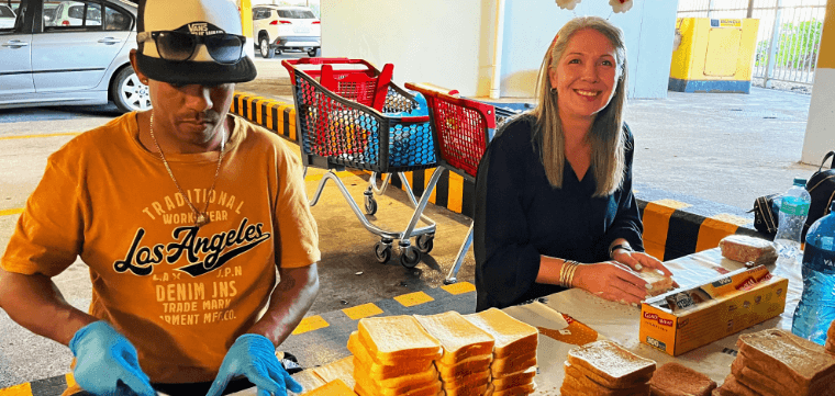 Volunteers assembling sandwiches at the soup kitchen station.